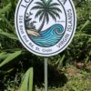 Custom tropical sign with hand-painted palm tree and ocean wave, designed for tropical-themed spaces or beach homes