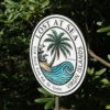 Fully customizable beach house sign with a tropical theme, featuring a palm tree and wave, perfect for personalizing your coastal property.