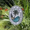 Custom tropical sign with hand-painted palm tree and ocean wave, designed for tropical-themed spaces or beach homes.